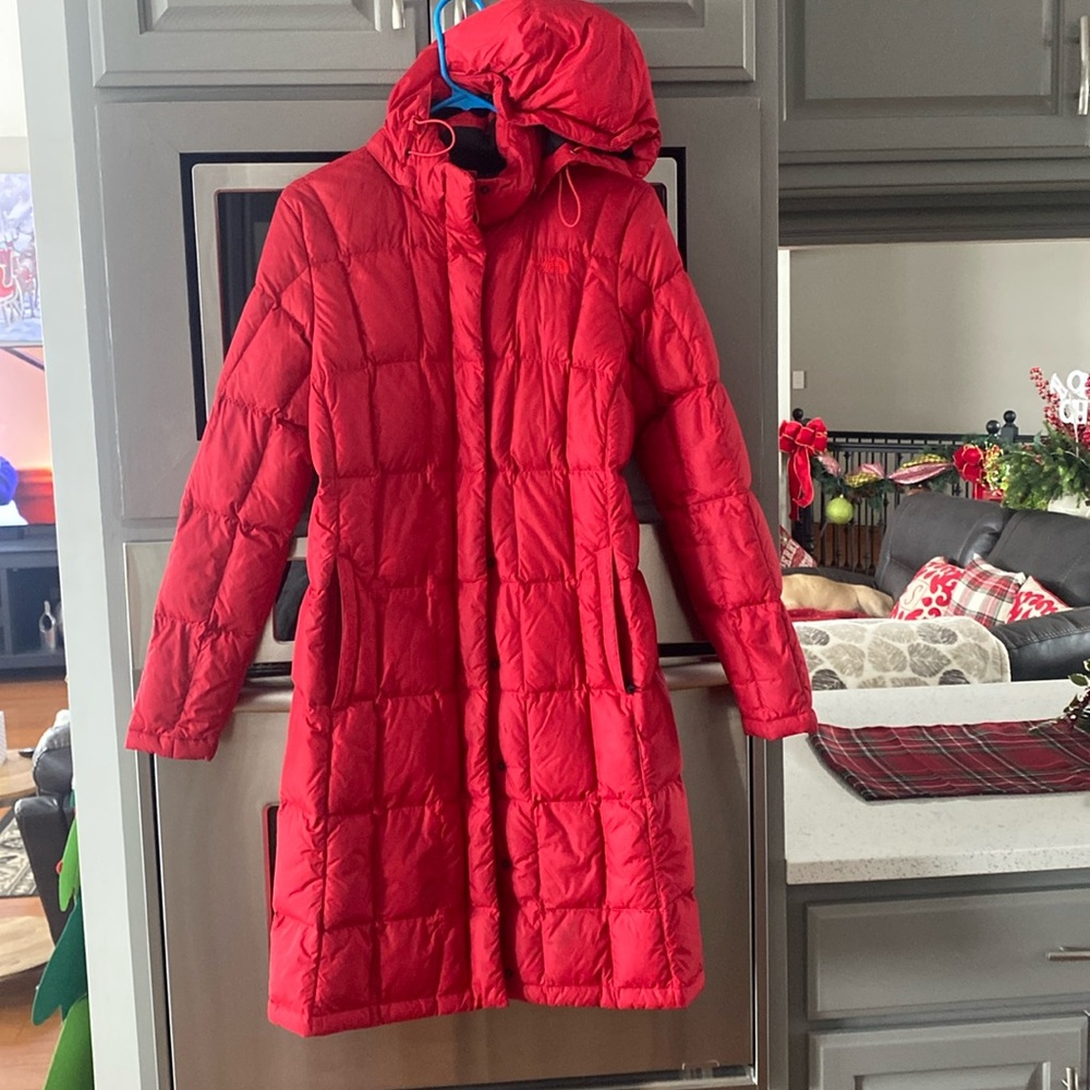 Red North Face knee length on a 5”7 person. Great shape!